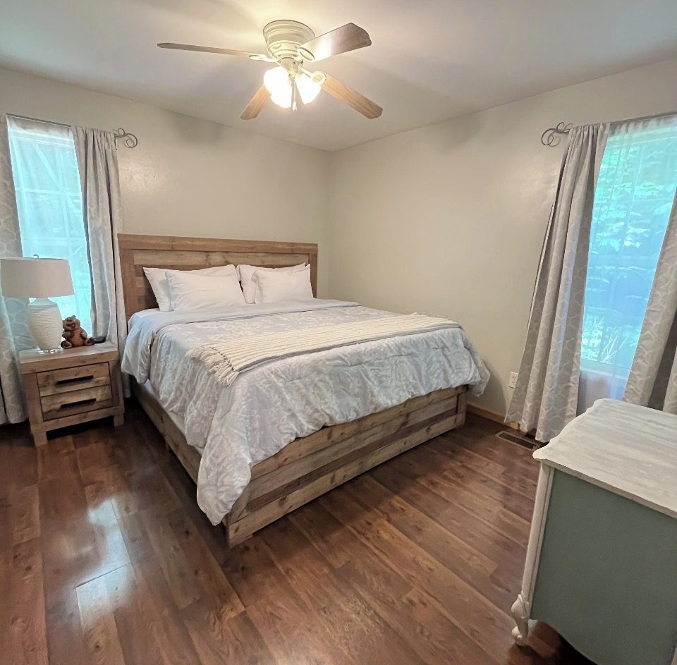 King bedroom with rustic wood bed frame