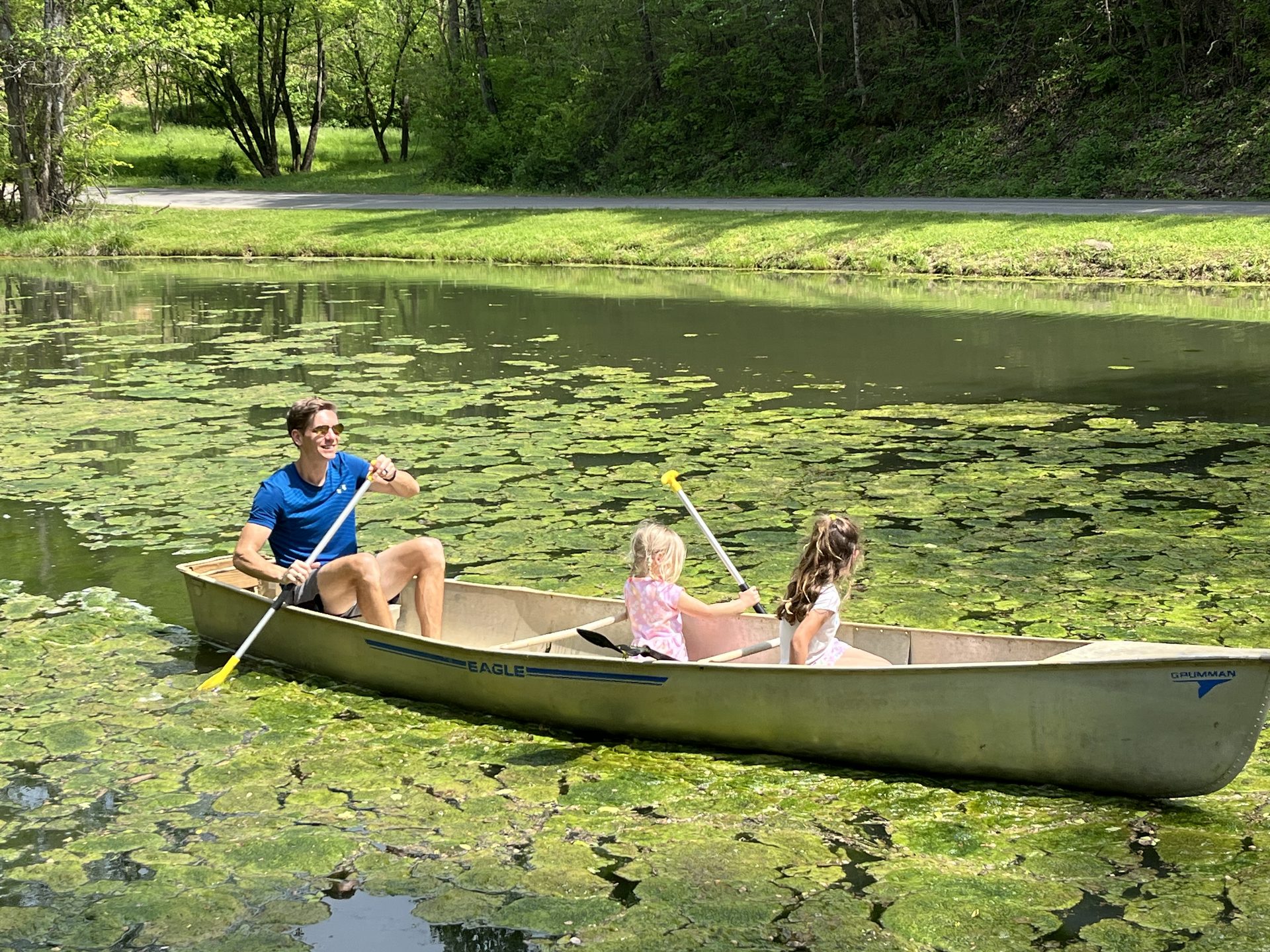 Family canoeing on the property's private catch-and-release pond